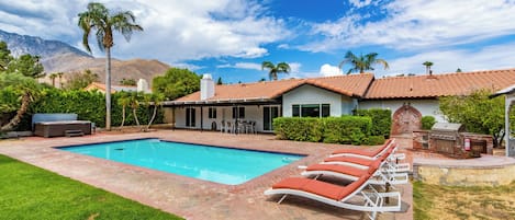 Backyard features a private pool and plenty of comfortable spaces to lounge.