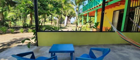 View from the covered patio with table, chairs and hammocks.