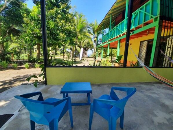 View from the covered patio with table, chairs and hammocks.