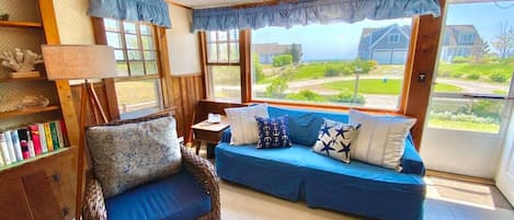 Sea Breeze Suite living room with view of beach path and ocean view over the rise.