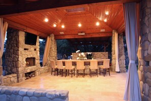 Outdoor kitchen with charcoal grill and 75 inch TV.  (Not shown in this photo)