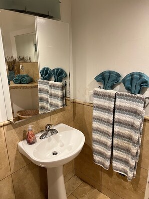 Pedestal sink with completely mirrored  oversized medicine cabinet 