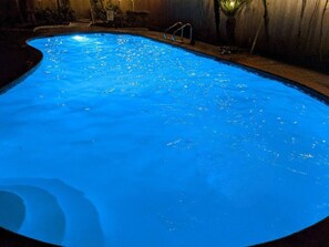 The pool at night. We have some backyard lighting and a pool light.