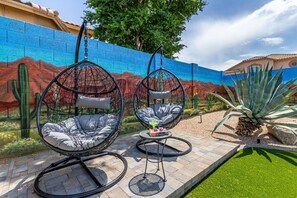 Relax in the cozy hanging ‘egg’ basket chairs while soaking up the sunshine in the resort-style backyard