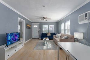 Luxuriate in the modern living room adorned with plush furnishings, bathed in natural light through floor-to-ceiling windows. The marble table, flat-screen TV, and warm wooden accents promise a stylish haven for relaxation or entertaining. Unwind in the lap of luxury!