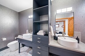 Modern bathroom with dual sinks, sleek design, and ample storage space.