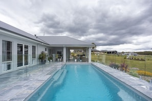 Marble outdoor tiling to complement mineral pool & outdoor cabana