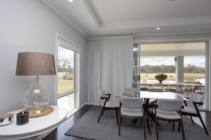 Indoor dining area with modern tempered glass and retro style dining chairs