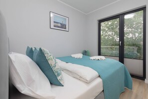 The cosy bedroom features a luxurious double bed and ample storage.