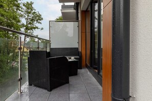 The balcony's stylish design complements the apartment's decor. 