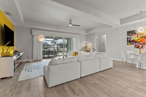 Living room with electric fireplace and large flat screen TV and connected PS4