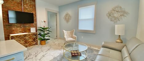 Adorable living room with tons of natural lighting and great ambiance. 