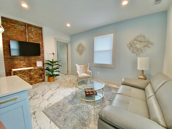 Adorable living room with tons of natural lighting and great ambiance. 