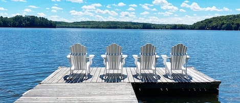 Enjoy the dock beautiful waterfront view from classic Muskoka Adirondack chairs.