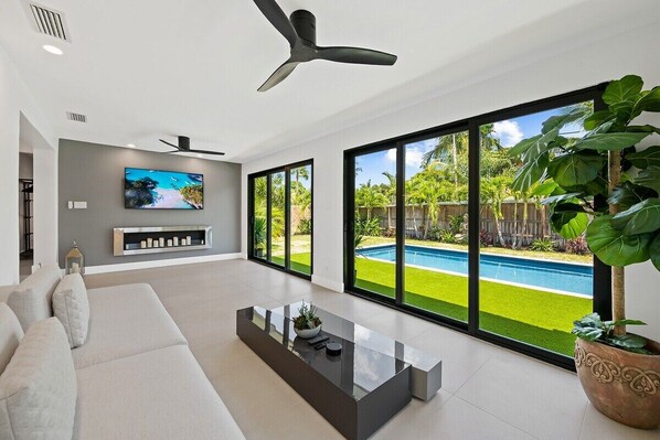 Spread out in the spacious open layout of this Wilton Manors pool home, which offers 3 bedrooms & 2 full bathrooms, natural light-filled living areas with comfy furniture and pool views, a modern dining table for six, fully-equipped kitchen with updated appliances and bar seating, separate laundry room and luxury modern decor throughout.