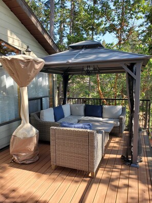 Top floor patio with gazebo, sectional and outdoor heater