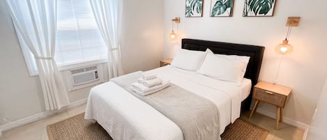 Comfortable queen-size bed with fresh white linens