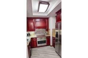 Full sized kitchen with refrigerator, oven, 4 burner stove, microwave, and washe