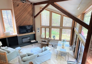 3 floor high windows showcase the natural light and peace of being out in nature