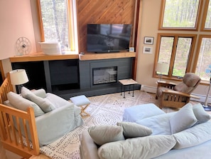 Cozy living rooming with extra comfy seating, electric fireplace and 65" ROKU TV
