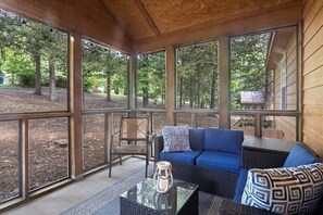 Lounge area on covered porch to relax and enjoy the outdoors without the bugs!