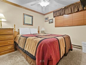 Queen-sized bed in bedroom; with Flat screen Tv