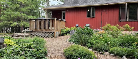 Peaceful perennial gardens surround one side.