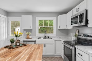 The large kitchen has new stainless steel appliances