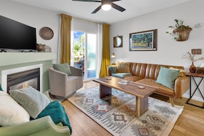 Smart TV, velvet curtains, and metal accents throughout.