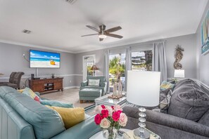 Bright and beautiful living room with sliding door access to open patio with seating area.