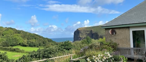 Seaside retreat, tucked away in hidden valley, a stones throw to sandy beach.