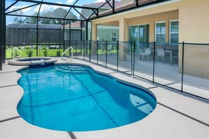 Relax in your private oasis with a sparkling pool and hot tub, perfect for unwinding under the sun.