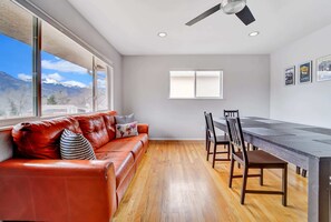 Sunlit Serenity in the Living Room! Experience an Inviting Ambiance with Abundant Natural Light and Captivating Views through the Spacious Window. Plenty of Seating for Everyone to Gather and Enjoy.
