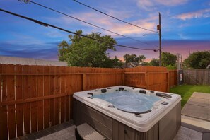 Hot tub with multiple hydrotherapy jets. Seats 7 people