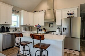 Kitchen with ice maker, coffee pot and Keurig with all kitchen supplies included