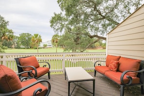 The back deck has sweeping views of the palmetto trees and live oak trees that line The Links golf course.