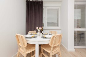 A dining area with wooden furniture and a window that lets in natural light, perfect for enjoying meals.

