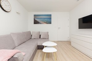 Another angle of the living area, featuring a comfortable sofa and a minimalist design.
