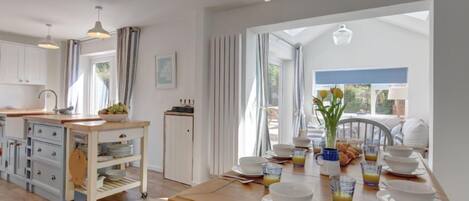 Egret, South Creake: The light and airy open plan kitchen / dining area, looking through into the sun room