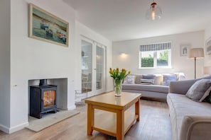 Egret, South Creake: The sitting room features comfortable seating and a wood burning stove