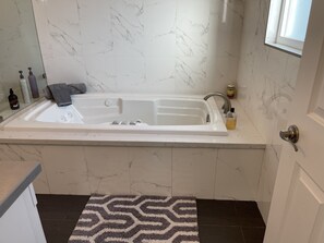 Soothing Deep Jetted Tub · Master Suite 