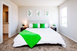 Master bedroom is stylish with a comfy king bed, an en suite bathroom, TV