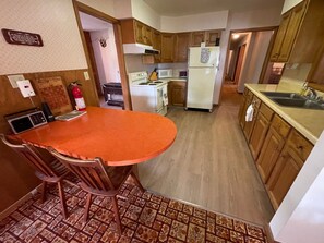 Kitchen is between the laundry room and dining room