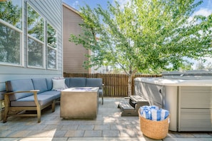 Hot tub and electric fire pit in the backyard.