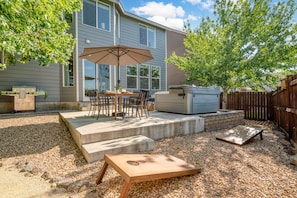 Spacious deck with an outdoor table and grill. Plus, cornhole is provided!