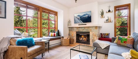 Spacious living room with lots of seating, 55" TV & cozy wood burning fireplace