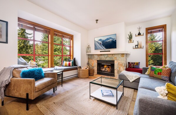 Spacious living room with lots of seating, 55" TV & cozy wood burning fireplace