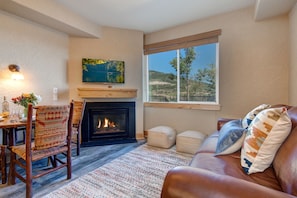 Living Room with gas fireplace, Samsung TV, and plush leather sofa sleeper