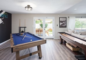Pool table and shuffleboard in living room