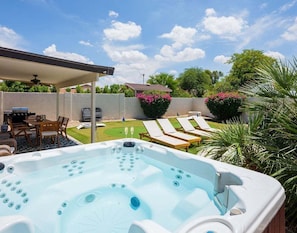 Backyard featuring pool, hot tub, putting green, bocce ball court, and outside dining area.